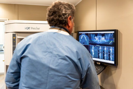 Peter Patellis - Dentist showing patients their xrays